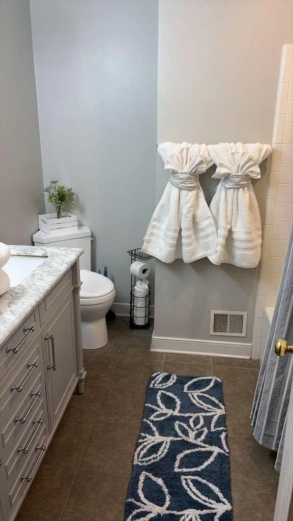 Bathroom with marble vanity and blue accents