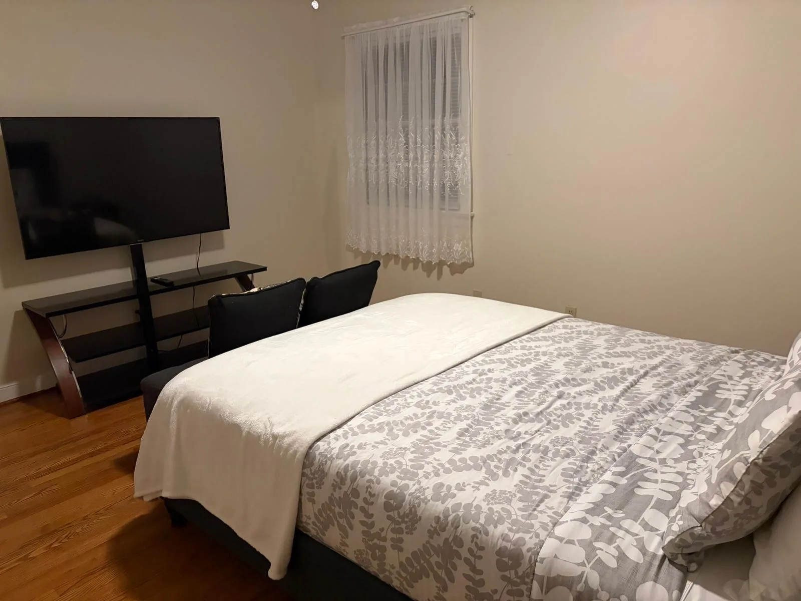Bedroom with queen bed and TV