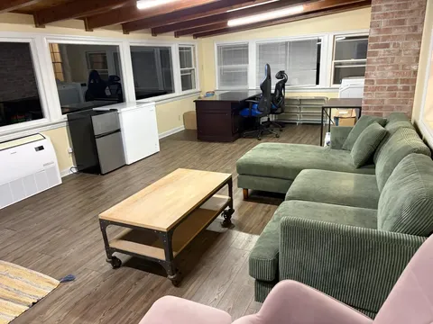 Bonus room with sectional sofa and desk