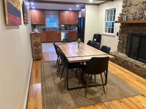 Dining room and kitchen with stone fireplace